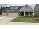 Charming home with a two car garage, gray and brick exterior, and a manicured front lawn at 2328 Eagle Shot Ct # 18, Fuquay Varina, NC 27526