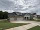 Charming home with a three car garage and gray and brick exterior at 2328 Eagle Shot Ct # 18, Fuquay Varina, NC 27526