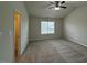 Spacious bedroom with plush carpet, a ceiling fan, and a walk-in closet at 271 Mayors Lane Ln, Wendell, NC 27591