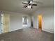 Neutral carpeted bedroom with ample space, complemented by a ceiling fan and a glimpse into the bathroom at 271 Mayors Lane Ln, Wendell, NC 27591
