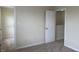 View of the bedroom with neutral carpet, featuring an open closet and a partially closed white door at 271 Mayors Lane Ln, Wendell, NC 27591