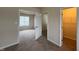 View of the bedroom with neutral carpet, with an open closet, and a view into another bedroom at 271 Mayors Lane Ln, Wendell, NC 27591