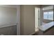 Neutral hallway, with a view into two rooms, one with a window, one with carpet at 271 Mayors Lane Ln, Wendell, NC 27591