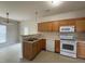 Functional kitchen featuring wood cabinets, an oven, and access to the dining area at 271 Mayors Lane Ln, Wendell, NC 27591