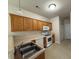 Bright kitchen featuring light wood cabinetry, white appliances, and tile flooring at 271 Mayors Lane Ln, Wendell, NC 27591