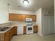 Well-lit kitchen features wood cabinets, white appliances, and tile flooring at 271 Mayors Lane Ln, Wendell, NC 27591