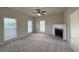 Bright living room featuring a cozy fireplace, neutral carpet, and abundant natural light at 271 Mayors Lane Ln, Wendell, NC 27591