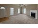 Bright living room featuring a cozy fireplace, neutral carpet, and abundant natural light at 271 Mayors Lane Ln, Wendell, NC 27591