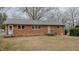 Back of house featuring brick exterior and walk-out access to the spacious backyard at 2720 Amherst Ave, Burlington, NC 27215