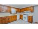Traditional kitchen featuring wood cabinets, white appliances, a double-basin sink, and natural light at 2720 Amherst Ave, Burlington, NC 27215