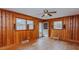 Wood-paneled room with hardwood floors, ceiling fan and multiple windows at 2720 Amherst Ave, Burlington, NC 27215