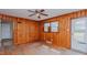 Wood-paneled living room with hardwood floors, ceiling fan and windows at 2720 Amherst Ave, Burlington, NC 27215