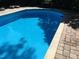 Cool blue in-ground pool with a brick surround, perfect for relaxation and enjoyment at 2930 Hostetler St, Raleigh, NC 27609