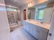 Bright bathroom featuring a double vanity and tiled shower with glass door at 394 Duncan Creek Rd # 158, Lillington, NC 27546