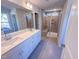 Bright bathroom features a double vanity with a large mirror and a spacious tiled shower with a built-in bench at 394 Duncan Creek Rd # 158, Lillington, NC 27546