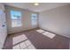 A bright, empty bedroom with carpet flooring and two windows at 394 Duncan Creek Rd # 158, Lillington, NC 27546