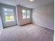 Bright bedroom with large windows providing ample natural light and cozy carpeting at 394 Duncan Creek Rd # 158, Lillington, NC 27546