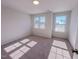 An empty bedroom with three windows that let in natural light at 394 Duncan Creek Rd # 158, Lillington, NC 27546