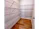 Walk-in closet with white wire shelving and hardwood flooring at 394 Duncan Creek Rd # 158, Lillington, NC 27546