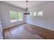 Dining room with hardwood floors, and large windows overlooking green trees at 394 Duncan Creek Rd # 158, Lillington, NC 27546