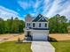 Two-story home with a two-car garage, well-manicured lawn, and landscaping at 394 Duncan Creek Rd # 158, Lillington, NC 27546