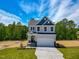 Charming two-story home boasts a well-manicured lawn, two car garage, and inviting curb appeal at 394 Duncan Creek Rd # 158, Lillington, NC 27546