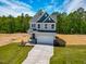 Two-story home with a two-car garage, well-manicured lawn, and landscaping at 394 Duncan Creek Rd # 158, Lillington, NC 27546