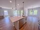 Open concept kitchen featuring an island with sink and stainless steel appliances at 394 Duncan Creek Rd # 158, Lillington, NC 27546