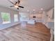 Living area with open concept kitchen boasts new ceiling fan and hard wood floors at 394 Duncan Creek Rd # 158, Lillington, NC 27546