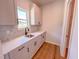 Bright kitchenette with white quartz countertops, undermount sink and tiled backsplash at 394 Duncan Creek Rd # 158, Lillington, NC 27546