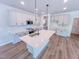 Modern kitchen with gray cabinetry, stainless steel appliances, and a large island at 394 Duncan Creek Rd # 158, Lillington, NC 27546