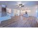 Open-concept living room with wood floors and a view into the kitchen and staircase at 394 Duncan Creek Rd # 158, Lillington, NC 27546