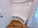 Mudroom with built-in shelving, bench, coat hooks and durable hardwood flooring at 394 Duncan Creek Rd # 158, Lillington, NC 27546