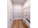 Walk-in pantry with wire shelving and wood-look flooring to easily store food, appliances, and other kitchen essentials at 394 Duncan Creek Rd # 158, Lillington, NC 27546