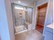 Close-up of tiled shower with glass door, seating, and small window at 394 Duncan Creek Rd # 158, Lillington, NC 27546