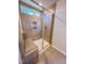 A tiled shower with a glass door features a built-in bench and shower niche at 394 Duncan Creek Rd # 158, Lillington, NC 27546