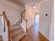 Classic staircase with carpeted steps, a wood handrail and white spindles leading to the upper level at 394 Duncan Creek Rd # 158, Lillington, NC 27546