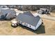 Expansive aerial view showcasing the house's roof, screened-in porch, and covered patio in a neighborhood at 405 Joseph Alexander Dr, Fuquay Varina, NC 27526