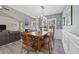 Bright dining room adjacent to the living room with a rustic wood table and wainscoting at 405 Joseph Alexander Dr, Fuquay Varina, NC 27526