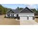 Charming one-story home featuring a three-car garage and a beautifully landscaped front yard at 405 Joseph Alexander Dr, Fuquay Varina, NC 27526