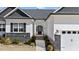 Inviting front entrance with a black door, complemented by manicured landscaping at 405 Joseph Alexander Dr, Fuquay Varina, NC 27526