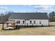 Back exterior featuring the covered patio with pergola, a garden, and a spacious backyard at 405 Joseph Alexander Dr, Fuquay Varina, NC 27526