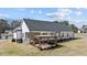 Rear exterior showcasing a screened-in porch and a covered patio with pergola, perfect for outdoor living at 405 Joseph Alexander Dr, Fuquay Varina, NC 27526
