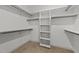 Walk-in closet featuring carpeted floors, built-in shelving and wooden hanging rods at 405 Joseph Alexander Dr, Fuquay Varina, NC 27526