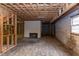 Basement space with bare framing and a rustic fireplace ready for customization or renovation at 407 Granville Rd, Chapel Hill, NC 27514