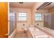 Bathroom featuring a dual sink vanity, bathtub with shower, and neutral colored walls at 407 Granville Rd, Chapel Hill, NC 27514