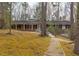 Charming brick home with a welcoming walkway, set amidst a natural landscape at 407 Granville Rd, Chapel Hill, NC 27514