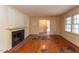 Cozy living room with hardwood floors, a classic fireplace, and bright windows offers a comfortable space at 407 Granville Rd, Chapel Hill, NC 27514