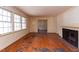 Bright living room features hardwood floors, large windows, and a traditional fireplace, perfect for relaxing at 407 Granville Rd, Chapel Hill, NC 27514