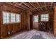 Unfinished living room with exposed beams and water-damaged walls awaiting its renovation at 407 Granville Rd, Chapel Hill, NC 27514